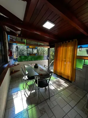 a dining room with a table and chairs on a patio at PurinkiWasi - La casa de todos in Los Reartes