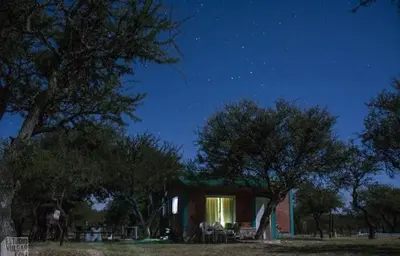 a small house with a window at night at Arcoiris de Cortaderas in Cortaderas