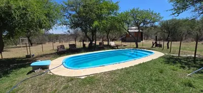 a swimming pool in a yard with a gazebo at Arcoiris de Cortaderas in Cortaderas