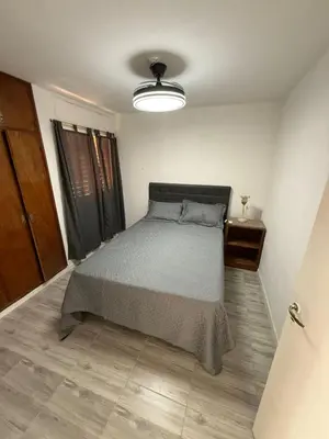 a bedroom with a bed and a lamp in it at Junior Towers Modern Apartment in Cordoba