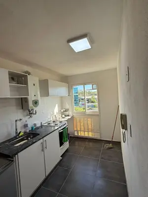a kitchen with white cabinets and a sink and a window at Junior Towers Modern Apartment in Cordoba