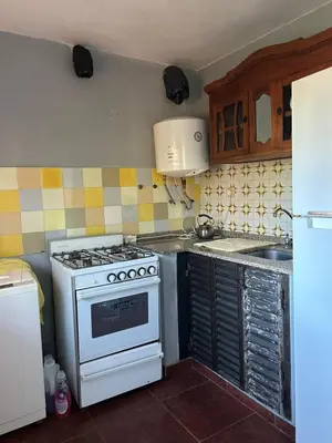 a kitchen with a stove and a sink at Casa Puna in Alta Gracia