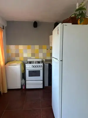 a kitchen with a white stove and a refrigerator at Casa Puna in Alta Gracia
