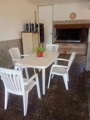 a white table and chairs in a room with a fireplace at La Soñada in Villa Parque Siquiman