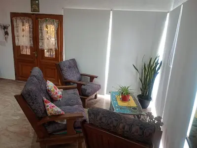 a living room with two chairs and a table at La Soñada in Villa Parque Siquiman