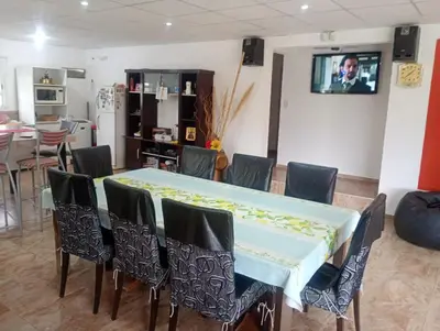 a dining room with a table and chairs at La Soñada in Villa Parque Siquiman