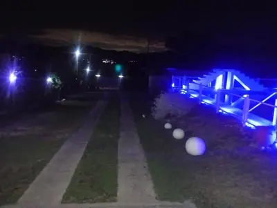 a street lit up at night with street lights at La Soñada in Villa Parque Siquiman
