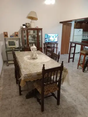 a dining room table with a vase on top of it at Complejo Alfa Iii in Villa Carlos Paz