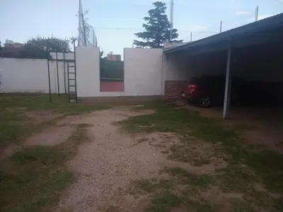 a car parked in a garage next to a building at Complejo Alfa Iii in Villa Carlos Paz