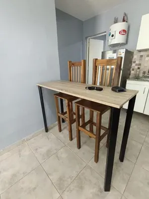 a wooden table and chairs in a kitchen at Depto Zenon para 3 personas in Pilar