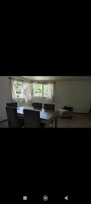 a dining room with a table and chairs and a window at La Julianita in Villa Cura Brochero