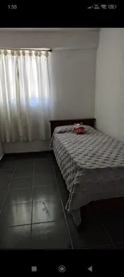 a bedroom with a bed and a window at La Julianita in Villa Cura Brochero
