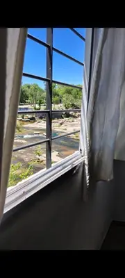 an open window with a view of a train at La Julianita in Villa Cura Brochero