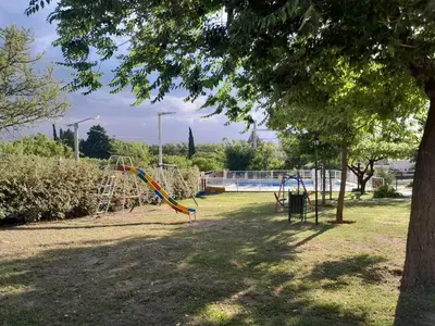 a playground with a slide in a park at Cabañas Nuestro Valle Cura Brochero in Villa Cura Brochero