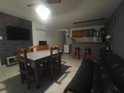 a kitchen and living room with a table and chairs at El burrito cordobés in Villa Santa Cruz del Lago