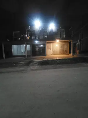 a house with two lights on top of it at night at El burrito cordobés in Villa Santa Cruz del Lago