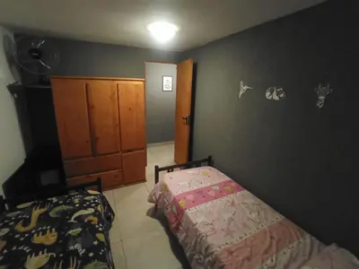 a bedroom with a bed next to a wall at El burrito cordobés in Villa Santa Cruz del Lago