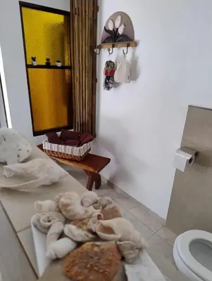a bathroom with a pile of towels on the floor at Linaje del Champaqui - San Javier in Villa de Las Rosas