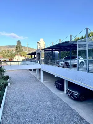 a parking lot with a car parked on a bridge at Complejo Carde Housing in Villa Carlos Paz