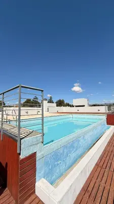 a swimming pool on the roof of a building at Complejo Carde Housing in Villa Carlos Paz