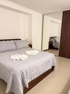 a bedroom with a bed with two towels on it at Complejo Carde Housing in Villa Carlos Paz