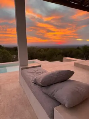 two pillows are sitting on a porch with a sunset at Casa Veta in La Porteña