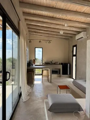 a living room with a table and a couch at Casa Veta in La Porteña