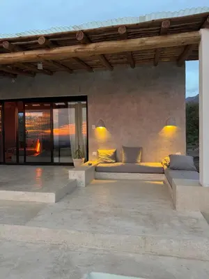 a outdoor patio with a couch and a fireplace at Casa Veta in La Porteña
