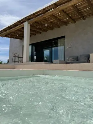 a swimming pool in front of a house at Casa Veta in La Porteña