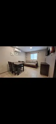 a living room with a table and a couch at Esencias Serranas in Cavalango