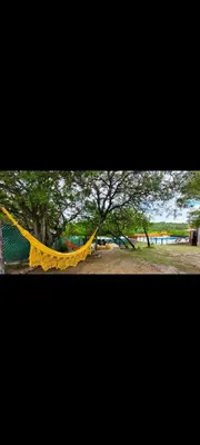 a yellow hammock in a park with a playground at Esencias Serranas in Cavalango