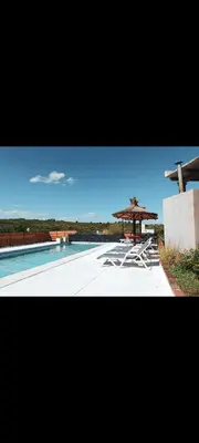 a swimming pool with a gazebo and a swimming pool at Esencias Serranas in Cavalango