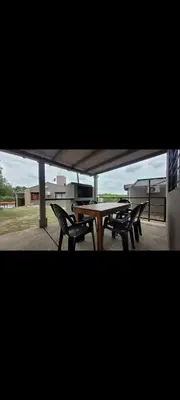 a picnic table and two chairs sitting under a tent at Esencias Serranas in Cavalango