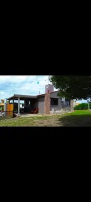 a large house with a large yard in front of it at Esencias Serranas in Cavalango
