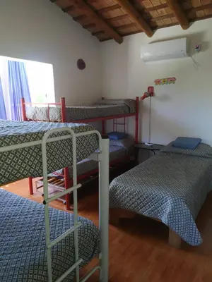 a room with four bunk beds and a window at Las Tole - Potrero de Garay in La Estancia