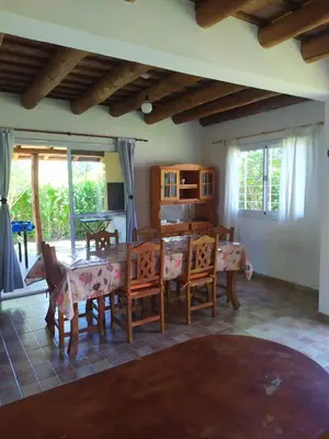 a living room with a dining room table and chairs at Las Tole - Potrero de Garay in La Estancia