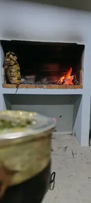 a fireplace with a fire in it and a plate at cabaña el lago in San Ignacio