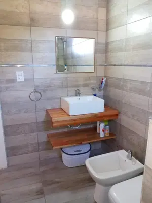 a bathroom with a sink and a toilet and a mirror at cabaña el lago in San Ignacio