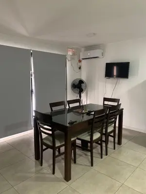 a dining room with a black table and chairs at Güemes Córdoba Area in Cordoba