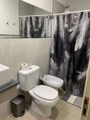 a bathroom with a toilet and a shower curtain at Güemes Córdoba Area in Cordoba