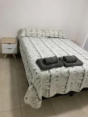 a bed with two pillows on it in a bedroom at Güemes Córdoba Area in Cordoba