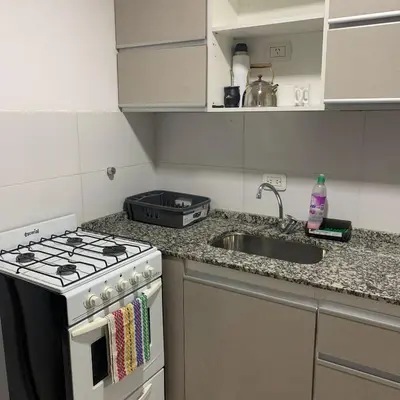 a kitchen with a stove and a sink at Güemes Córdoba Area in Cordoba