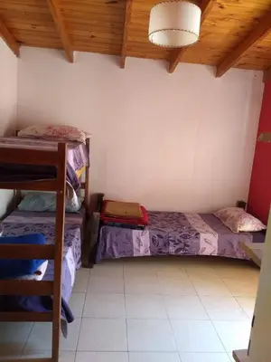 a room with two beds and a wooden ceiling at Cabañas El DESCANSO in Cordoba