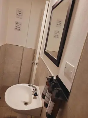 a bathroom with a white sink and a mirror at Departamento Patio Olmos in Cordoba