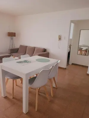 a white table and chairs in a living room at Departamento Patio Olmos in Cordoba