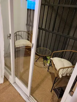 a room with two chairs and a glass door at Departamento Patio Olmos in Cordoba