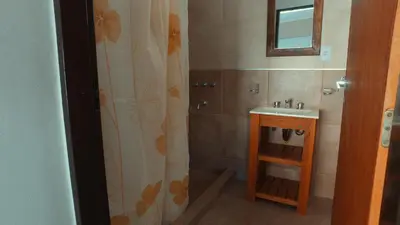 a bathroom with a sink and a shower curtain at Vila Aparts in Mina Clavero