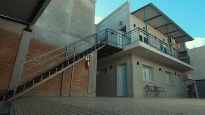a building with a staircase on the side of it at Vila Aparts in Mina Clavero