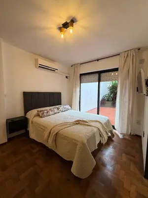 a bedroom with a bed and a ceiling fan at Horse Petit Apartments in Cordoba
