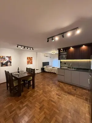 a kitchen and dining room with a table and chairs at Horse Petit Apartments in Cordoba